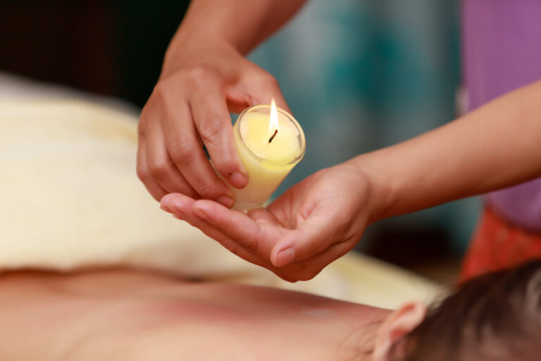 Asian woman enjoying a salt scrub massage at spa