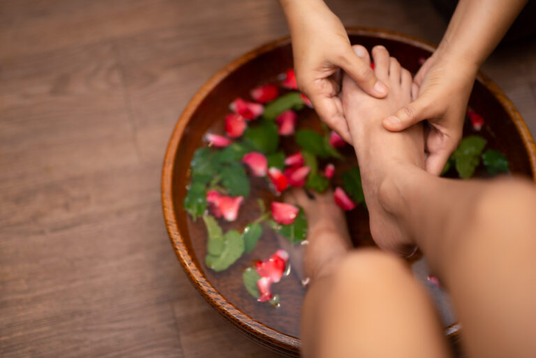 Top View shot of a woman feet dipped in water with petals in a